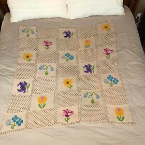 Crochet beige afghan with multicolored floral squares